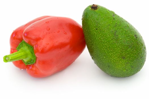 Red sweet pepper and green avocado on a white background