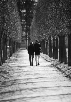 The man and the woman walk in park, b/w