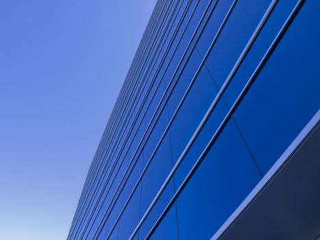 Blue windows reflecting the clear blue sky.