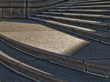 Evening summer light and shadow detail on a granite staircase