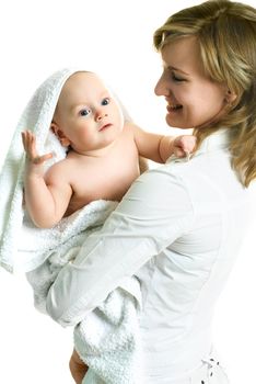 young happy beautiful mother with her little baby wrapped into the towel against white background