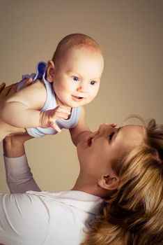 portrait of a happy young mother playing with her baby