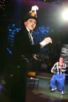 The clown makes a trick with fire