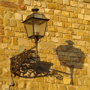   old lantern on the wall in Florence, Tuscany, Italy.                      