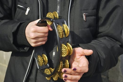 street musician, womans hands keeps tambourine