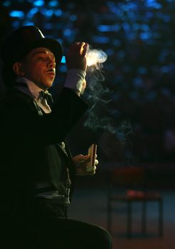 The clown makes a trick with fire