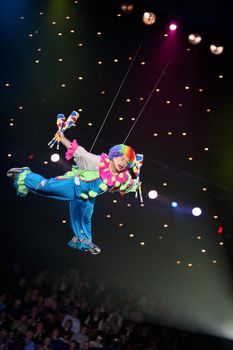 clown - air acrobat carry out dangerous exercise under a dome of a circus