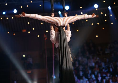 Girl - air acrobat carry out dangerous exercise under a dome of a circus