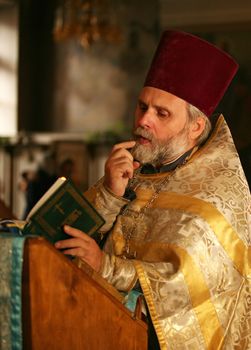 The priest with the Bible on ceremony of wedding of a newly-married couple. Moscow, the Patriarchal farmstead