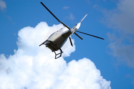The helicopter in the sky with clouds