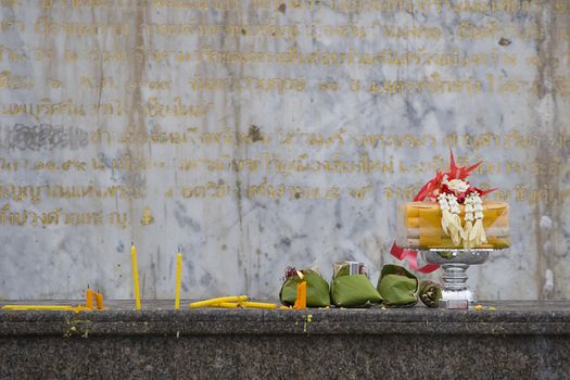 Thai prayer props in Chiang Mai, Thailand. Inscriptions in the background. 