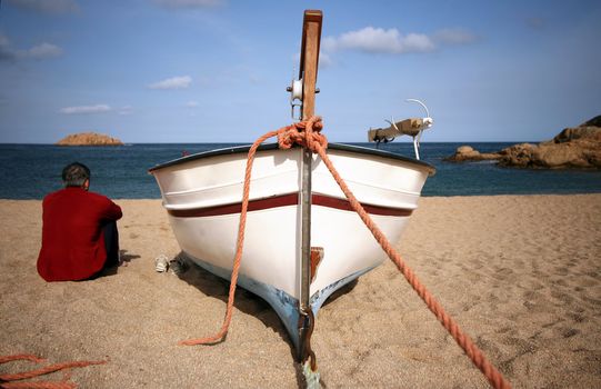 Lonely the man on seacoast. Spain. Tossa