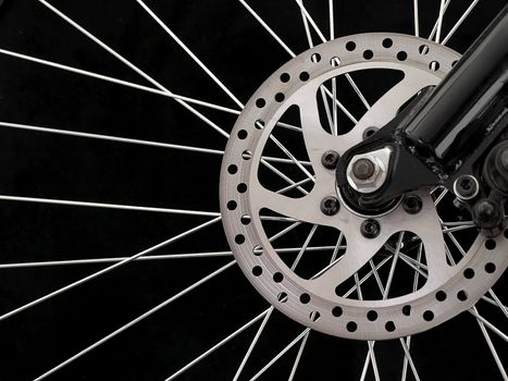 Bicycle disc brakes isolated on a black background.
