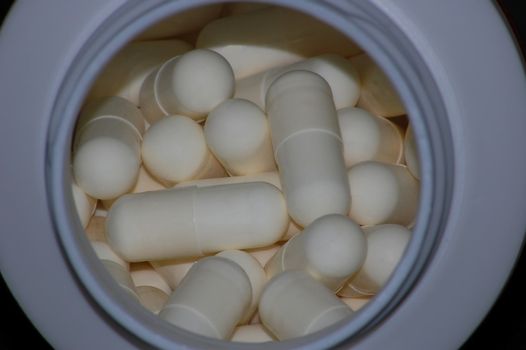 capsules in box isolated on the black background