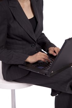 A young business woman is using a laptop