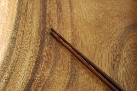 wooden plate waiting for sushi meal with chopsticks
