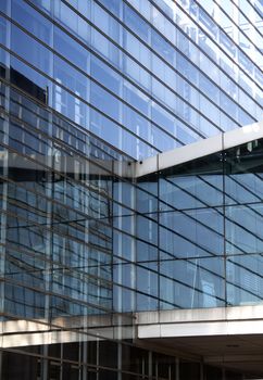 An impressive glass skyscraper with a glass bridge connecting two buildings