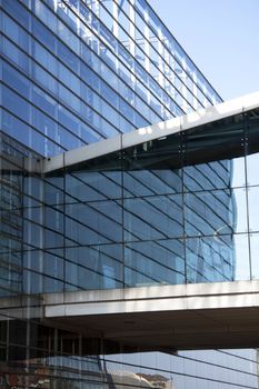 An impressive glass skyscraper with a glass bridge connecting two buildings