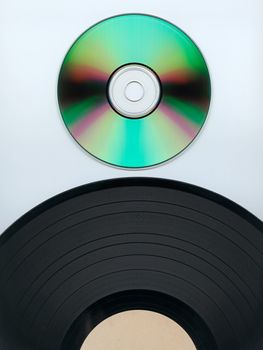 Close up of a cd and partial record over white