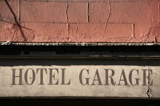 HOTEL GARAGE sign - vintage notice on a decaying building