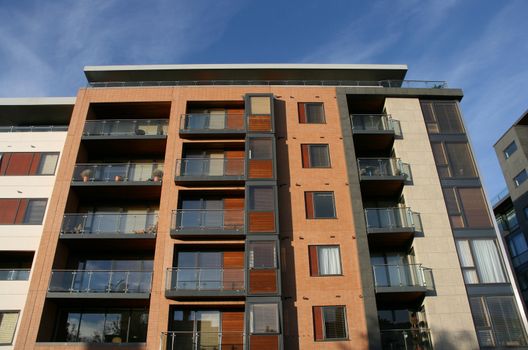 Modern apartment building in Dublin, Ireland. Blue sky in background.