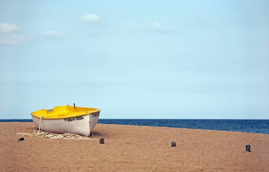 Lonely the boat on seacoast. Spain. Tossa