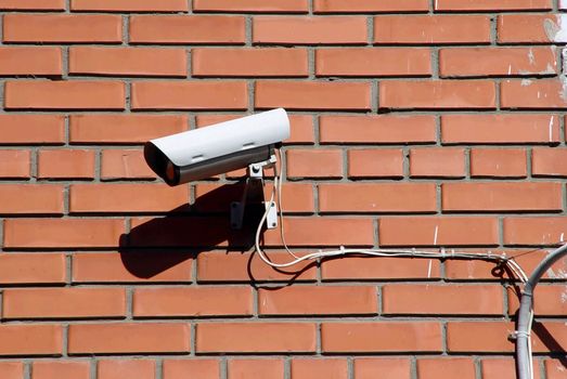 Security camera on a brick wall