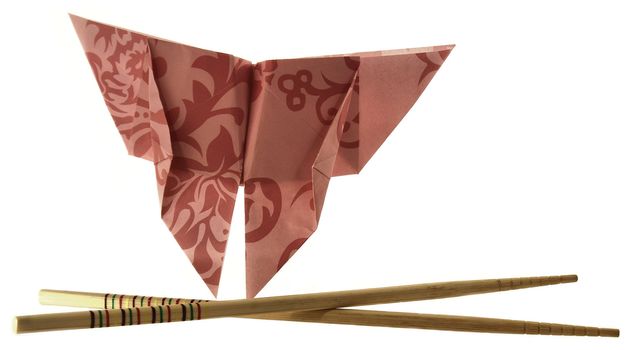 floral origami butterfly with crossed wooden chopsticks