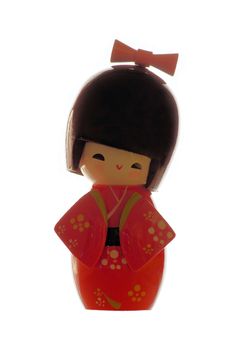 Japanese Kokeshi doll wearing red kimono