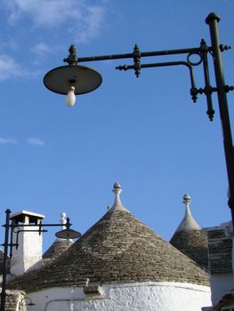  trulli houses in Alberobello, town in Italy. Trulli are local,traditional Apulian stone dwelling with a conical roof. They may be found in the towns of Alberobello, Locorotondo, Fasano, Cisternino, Martina Franca and Ceglie Messapica.