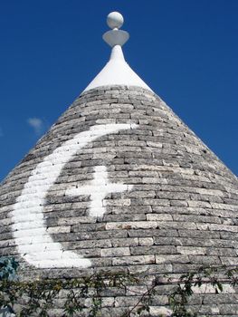 painted magical symbol on roof of trullo house in Alberobello,Puglia, Italy.