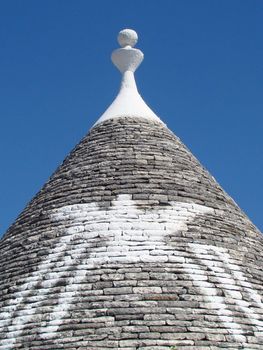 painted magical symbol on roof of trullo house in Alberobello,Puglia, Italy.