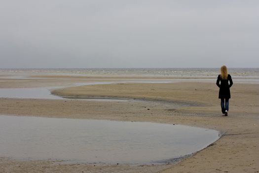 A lonely girl standing at the seashore