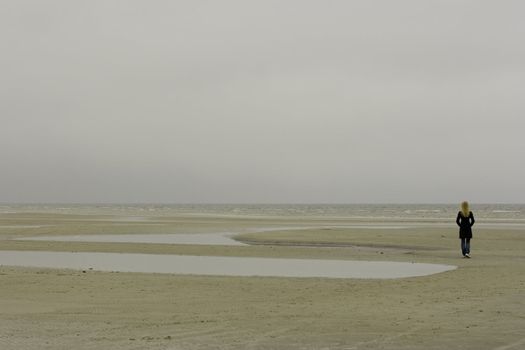 A lonely girl standing at the seashore