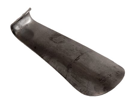 An old metal shoehorn on a white background