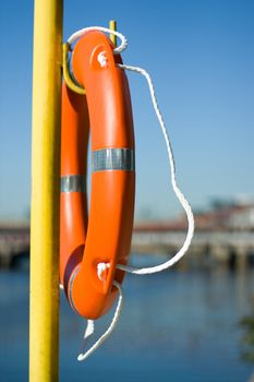 Orange life buoy hanging near the river