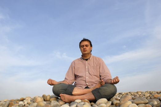 young man at the beach in meditation