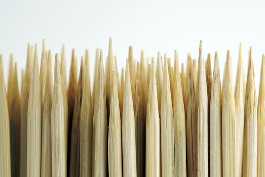 Sharpened bamboo skewers against white background