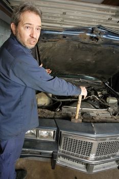 A bewildered mechanic unsure of what is wrong with the old car.
