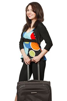 A beautiful brunette waiting to travel with a black suitcase.  Isolated on a white background.
