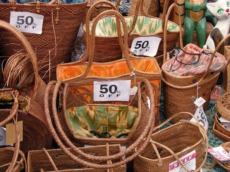 Discounts on a wooden woman bags stall in a Japanese market          