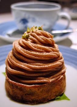 Still life with cake and coffee cup on a confectionery table.Selective focus on the cake.          