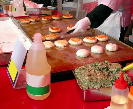 Detail of a festival street table-cooking Chinese hamburgers.         