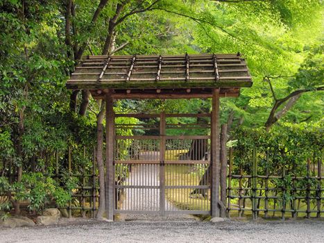 Wooden gate in a Japanese garden. Location: Golden Temple, Kyoto, Japan.          
