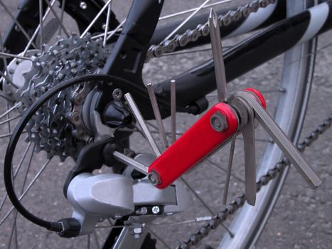 Multi folding tool fixed in a back pinions group.Useful image for designs connected with bicyle gear.Selective focus on the tool.          