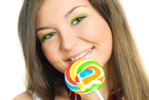 portrait of a pretty brunette girl eating a candy and smiling