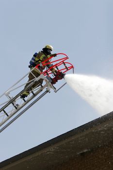 Firefighters battle a three alarm blaze.