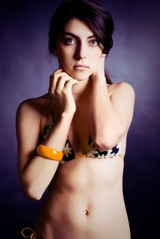 studio portrait of a beautiful slim model wearing bikini