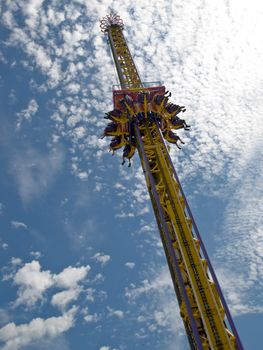 A thrilling ride at the fair that drops you in a controlled fal.
