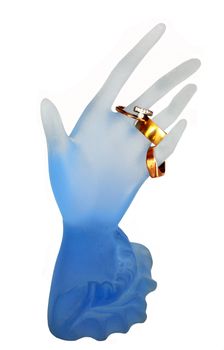 object on white: blue glassy arm with gold rings on it